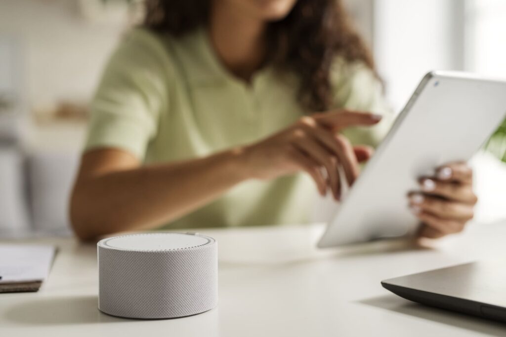 Woman with a tablet and a voice service assistant